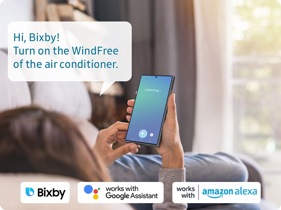 Bespoke AI WindFree Inverter Split AC, AR60H18D15W, 4.75 kW, 5 Star (2026) - Shows a person relaxing while controlling the air conditioning with their voice using a voice assistant on their smartphone, such as Samsung Bixby, works with Amazon Alexa or Google Assistant. The example voice command show
